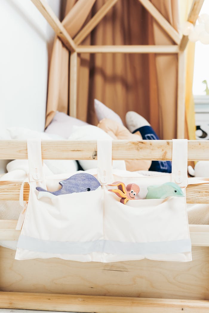 Charming childrens bedroom decor featuring a wooden bed and soft animal toys for a cozy atmosphere.